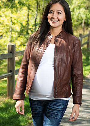 Pregnant woman outdoors walking.