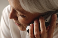 Older woman talking on a telephone